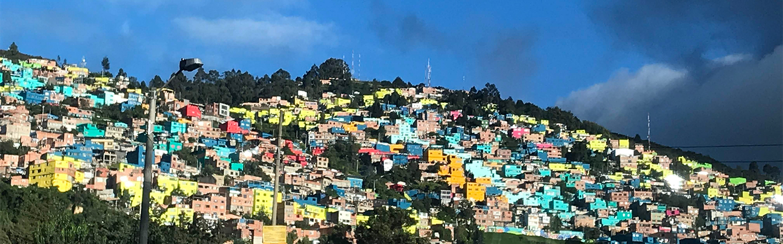 Hill filled with colorful buildings that are close together.